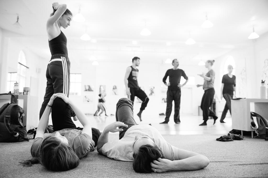 Dancers stretch between rehearsals at Northwest Dance Project